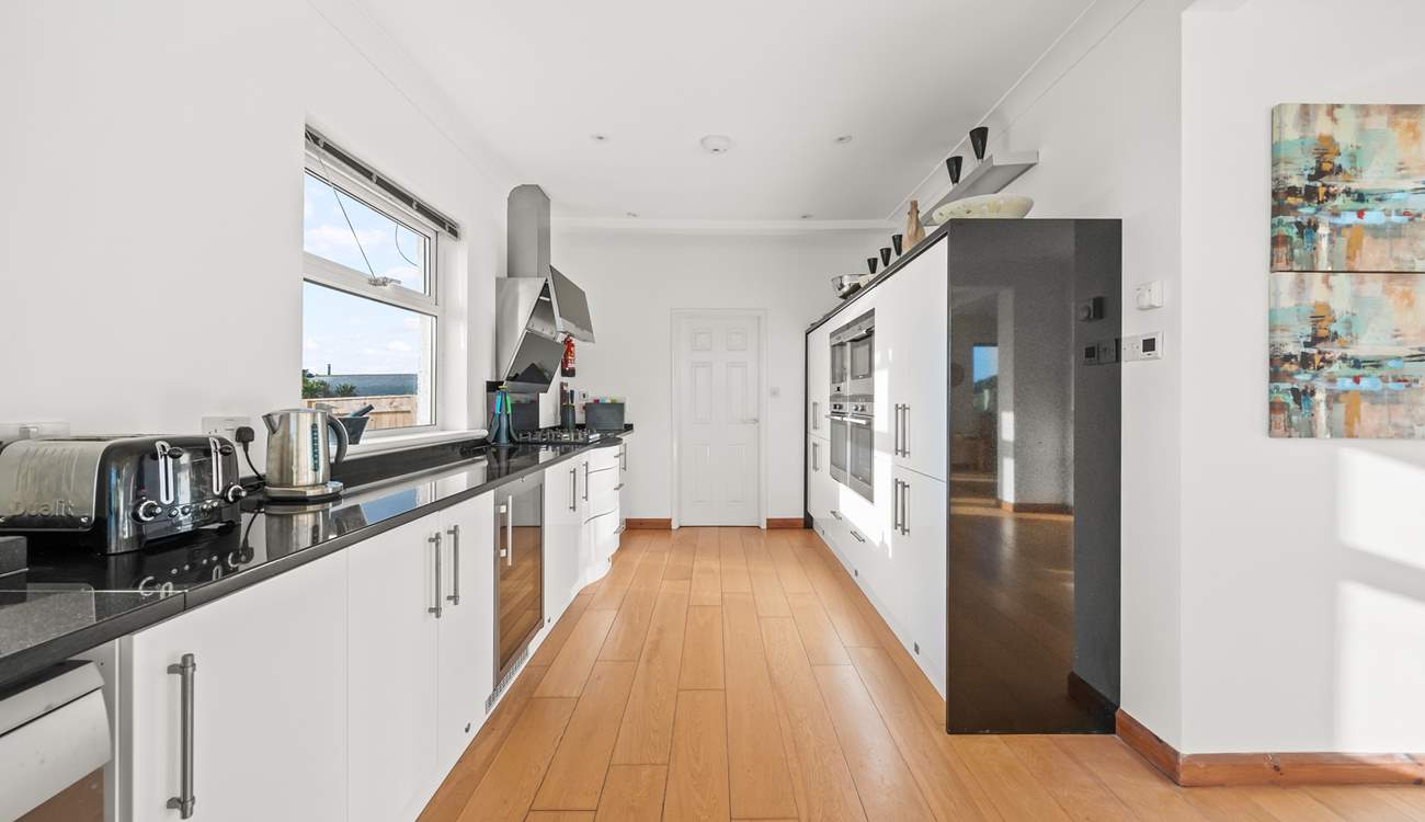 The kitchen leads into a rather large and handy utility-room.