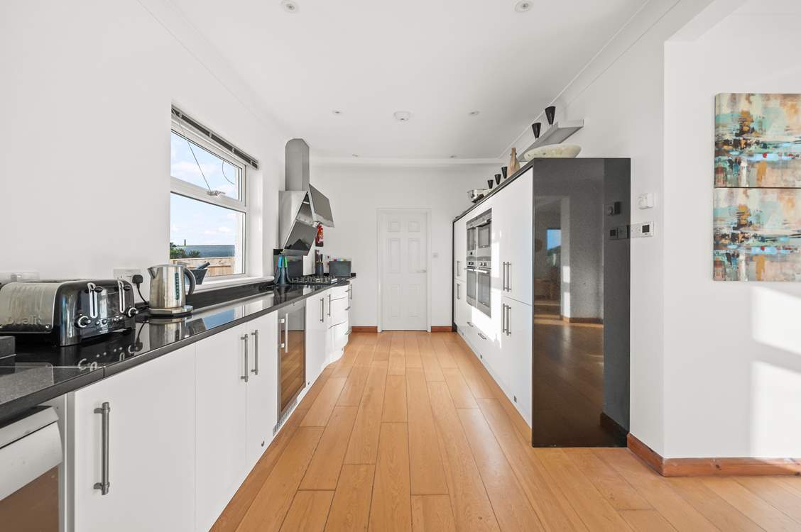 The kitchen leads into a rather large and handy utility-room.