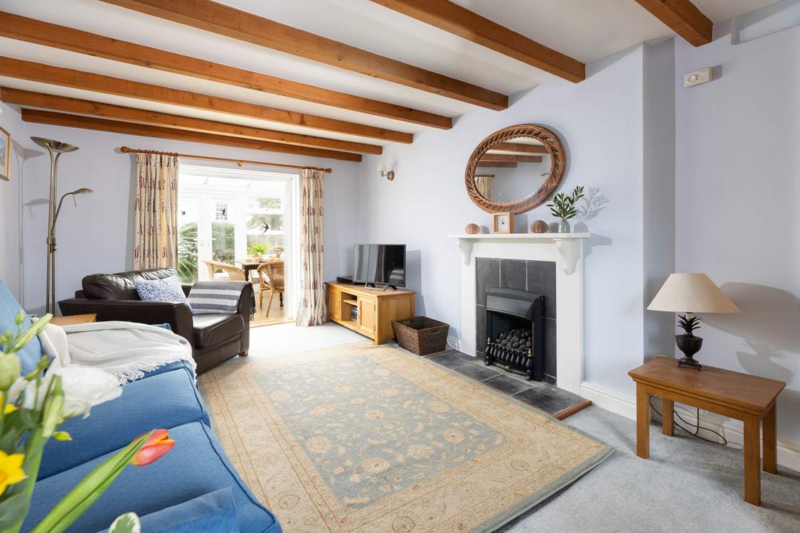 The cosy sitting-room has access to the conservatory.