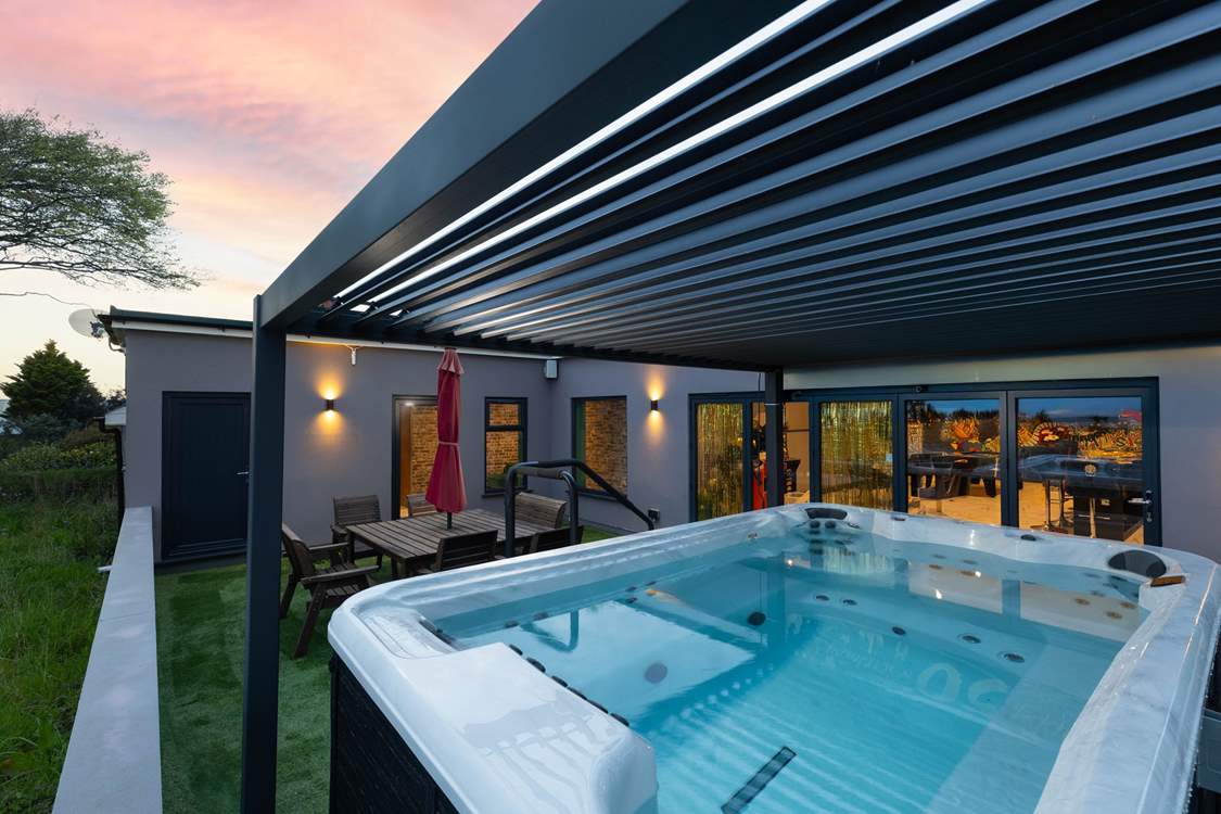 Relax in the hot tub at dusk.