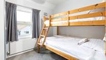 Bedroom 3 with seaside glimpses has triple bunk-beds with double bottom bunk and small single top bunk (2'6