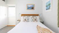 Bedroom 1, a double with en suite shower-room and access to the balcony, has steps leading to the rear terraces. 