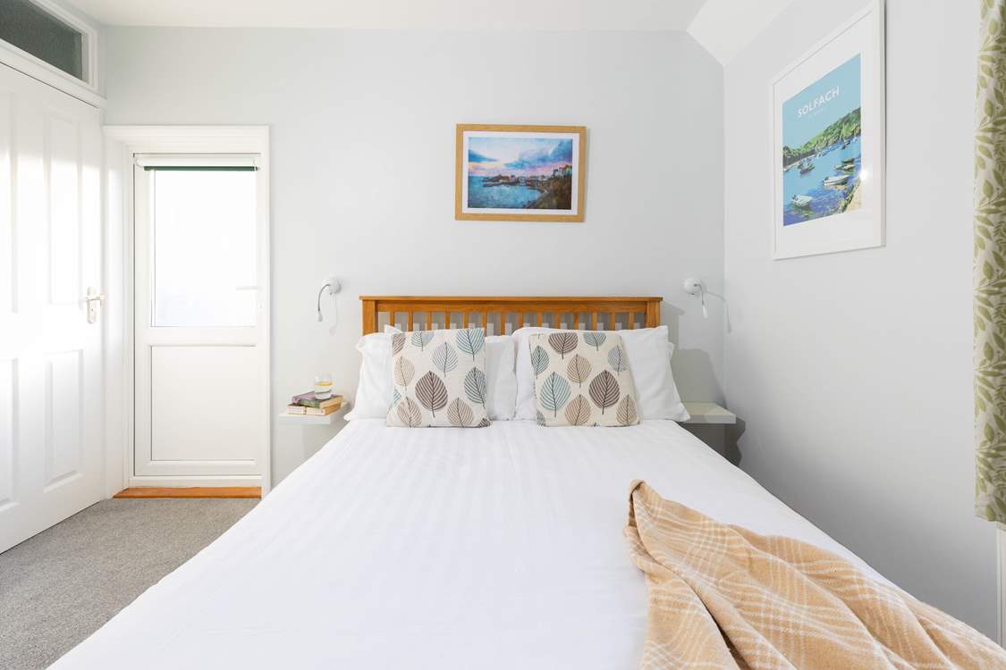Bedroom 1, a double with en suite shower-room and access to the balcony, has steps leading to the rear terraces.