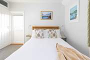 Bedroom 1, a double with en suite shower-room and access to the balcony, has steps leading to the rear terraces.