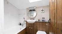 Behind the traditional door there is a modern bathroom.