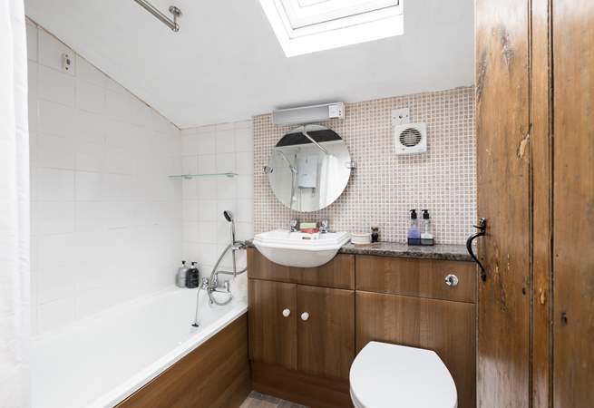 Behind the traditional door there is a modern bathroom.