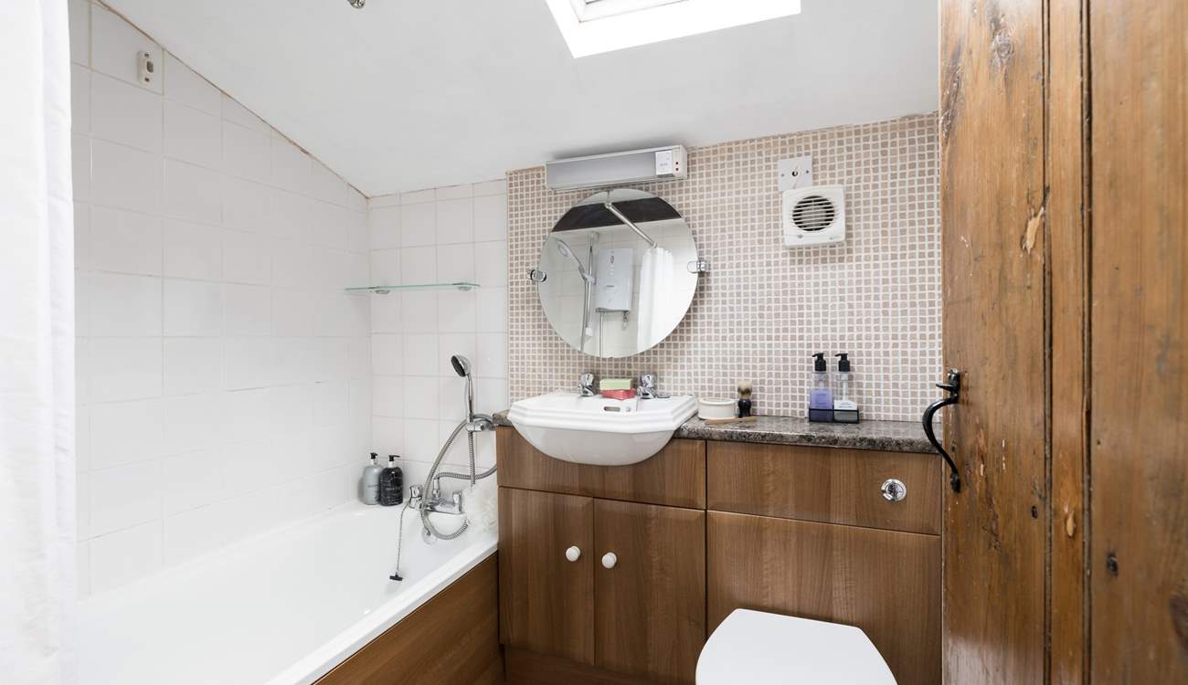 Behind the traditional door there is a modern bathroom.