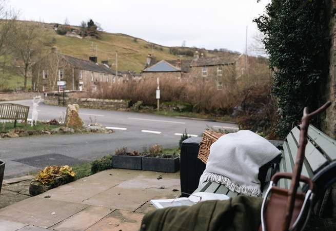 Enjoy a moment on the bench outside watching village life go by.