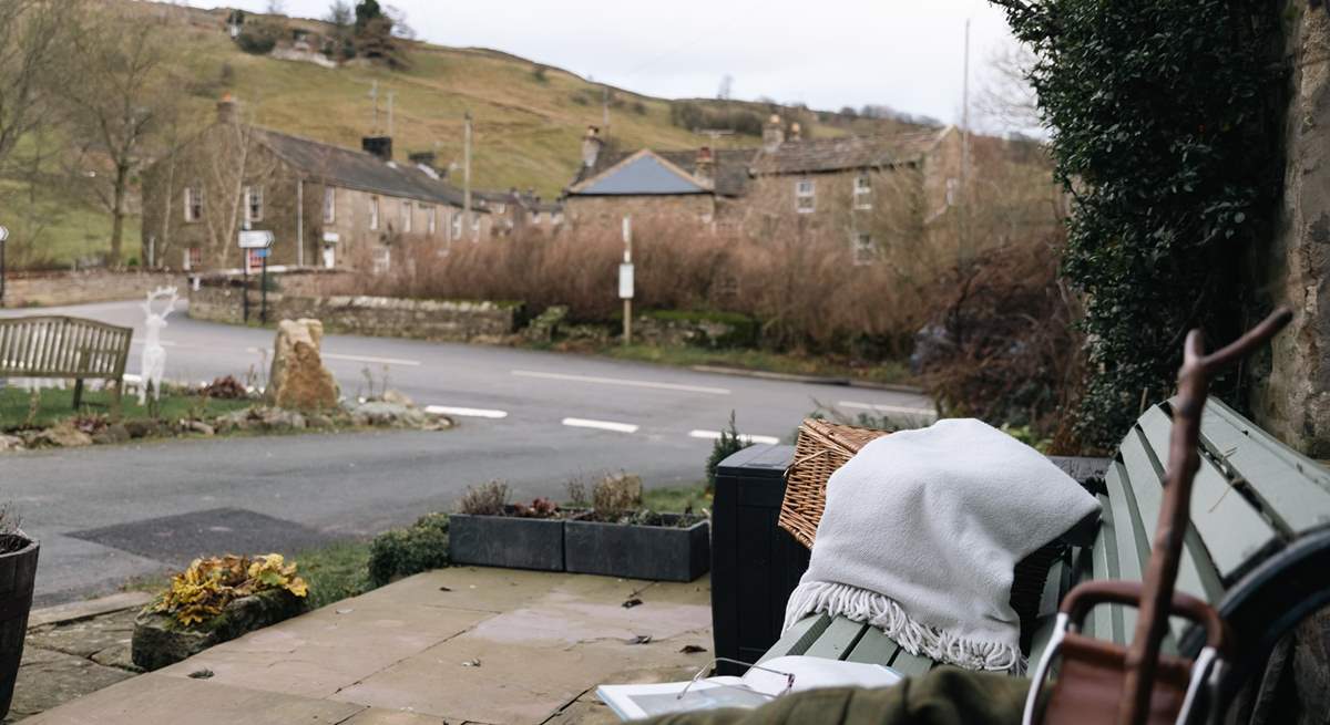 Enjoy a moment on the bench outside watching village life go by.