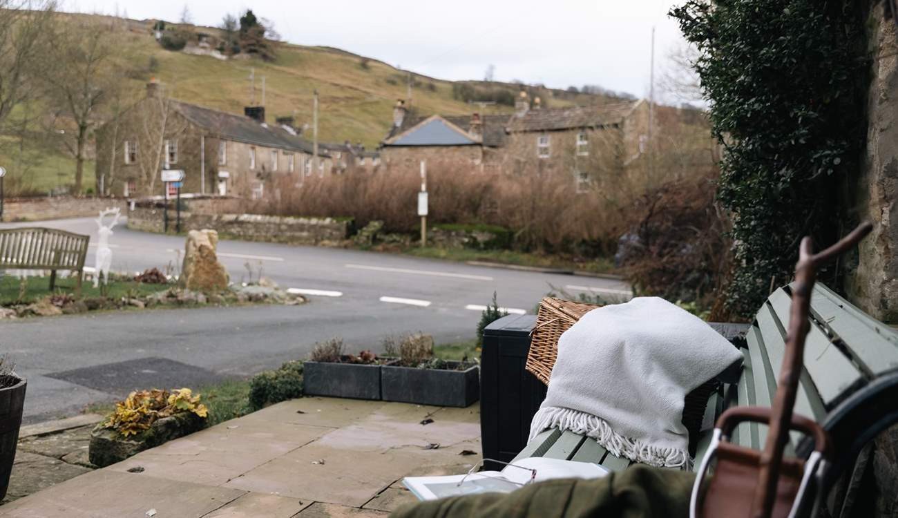 Enjoy a moment on the bench outside watching village life go by.