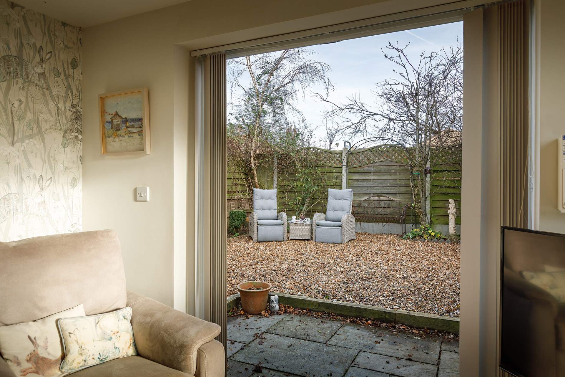 Open up the patio doors unto the sheltered garden.