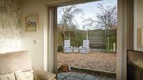 Open up the patio doors unto the sheltered garden.