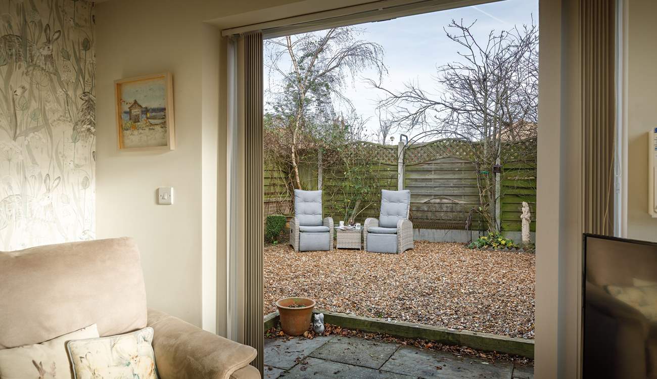 Open up the patio doors unto the sheltered garden.