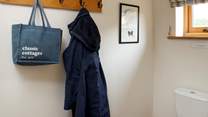 Ground floor cloakroom with space to hang bags and coats.