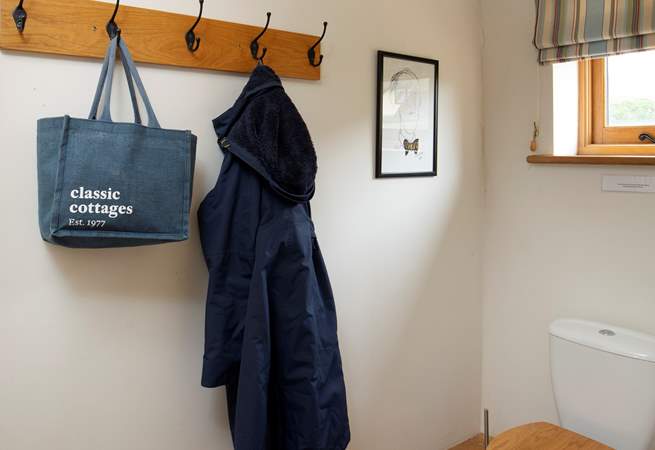 Ground floor cloakroom with space to hang bags and coats.