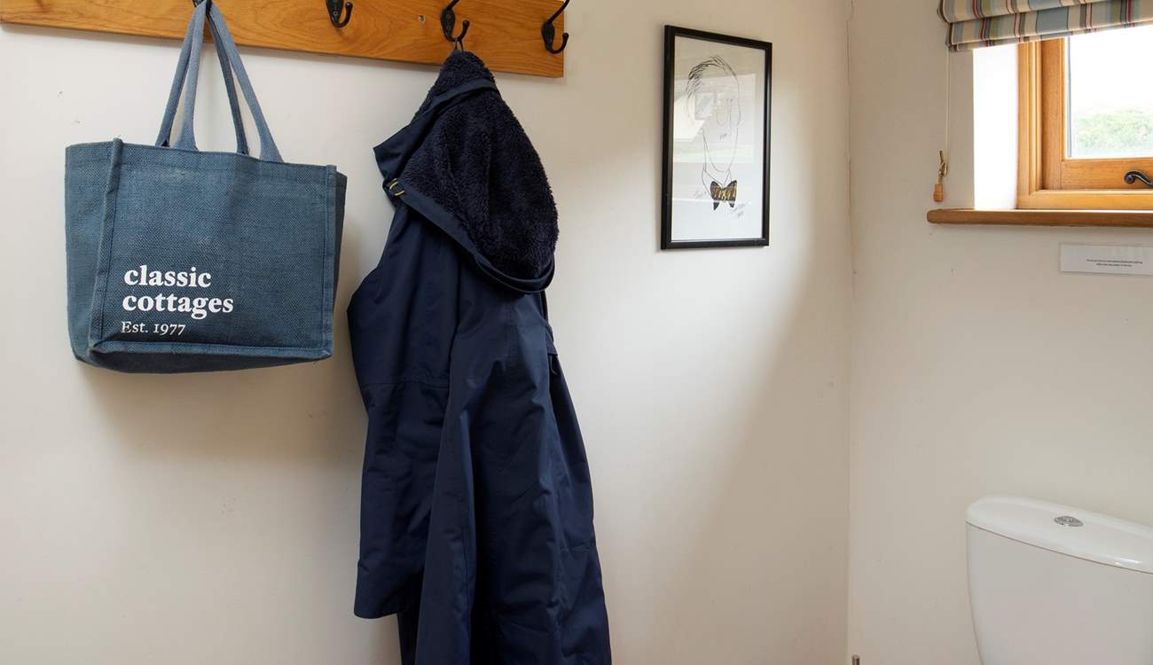 Ground floor cloakroom with space to hang bags and coats.