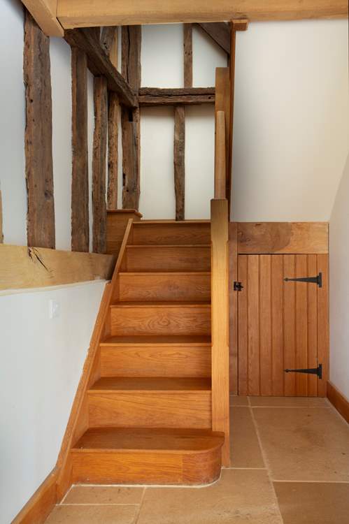 Stairs lead to the east wing and landing, lead to bedroom 2.