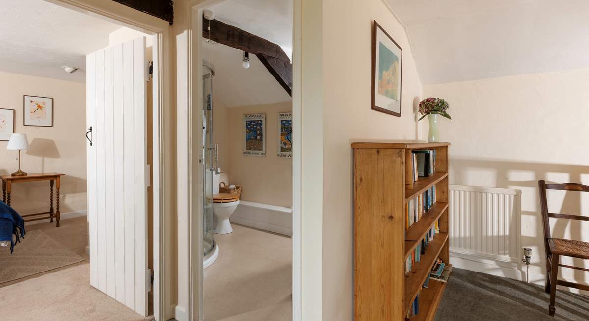 Peeking through to the first floor shower-room and double bedroom.