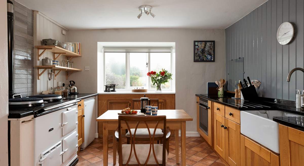 The country style kitchen is ideal for cooking up feasts. (Please note the Aga is ornamental and not for guests' use).