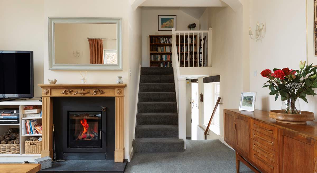 The sitting-room is on a split level - four steps up from the dining-room with stairs then rising to the first floor.