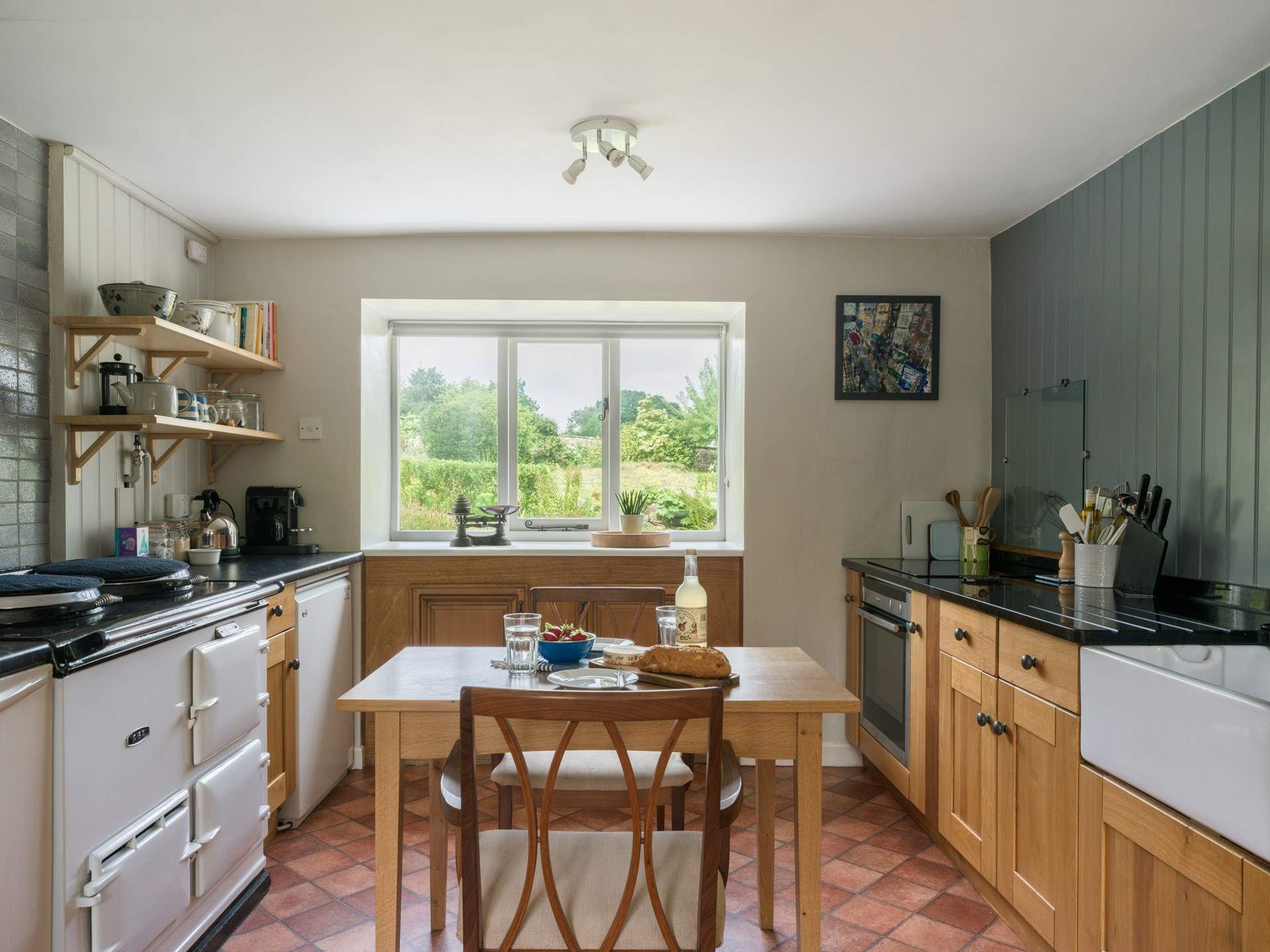 The country style kitchen is ideal for cooking up feasts and soaking in the beautiful gardens.