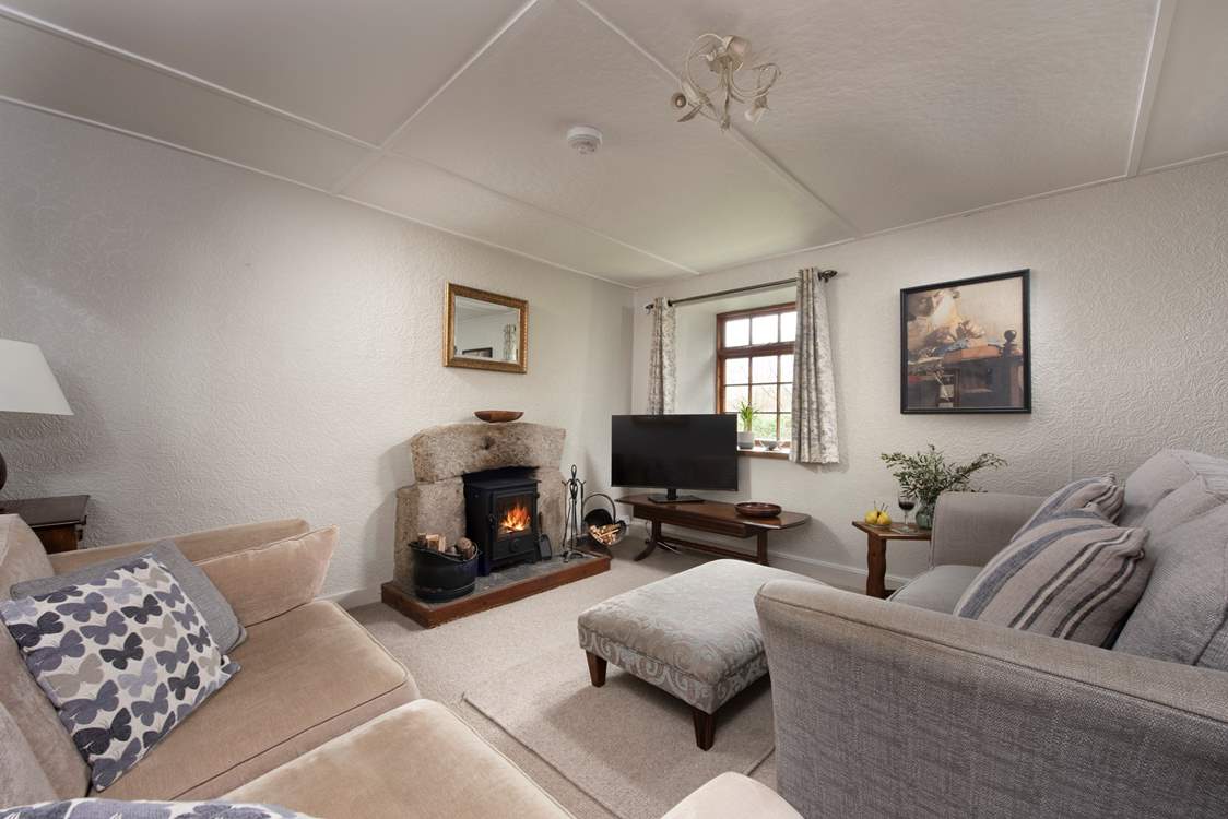 A cosy sitting-room with a sweet wood-burner to warm those chillier evenings.