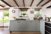 With wooden floors and rustic beams in the open plan area and a bespoke kitchen that is well-equipped for two lucky guests.