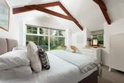 A stunning bedroom with king-size 'zip and link' luxury bed with views over the grounds and woodland beyond.