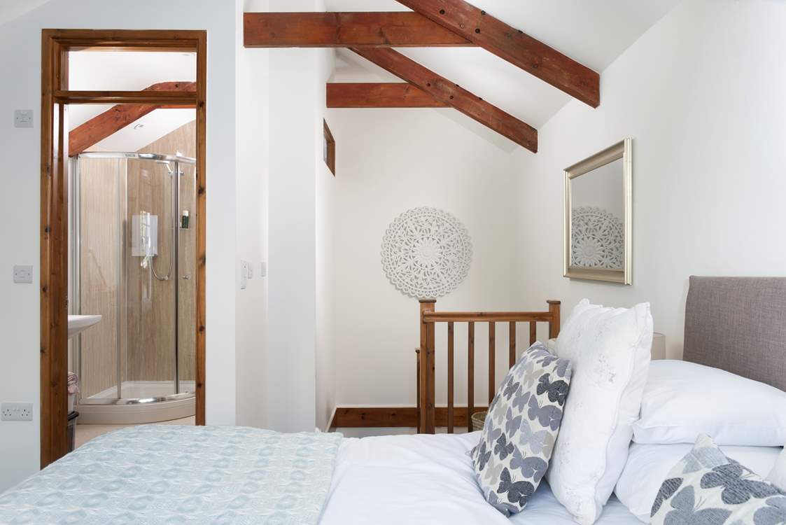 A wide staircase leads downstairs to the open plan living area.