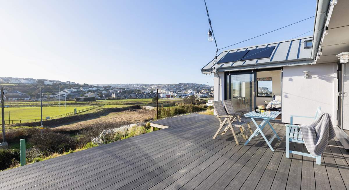 The large terrace has a lovely outlook over fields and Perranporth (there will be a low fence/ planters on the edge of the decking and new furniture too). 