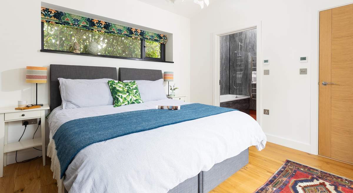 A calming light bedroom with 'zip and link' beds and en suite bathroom. 