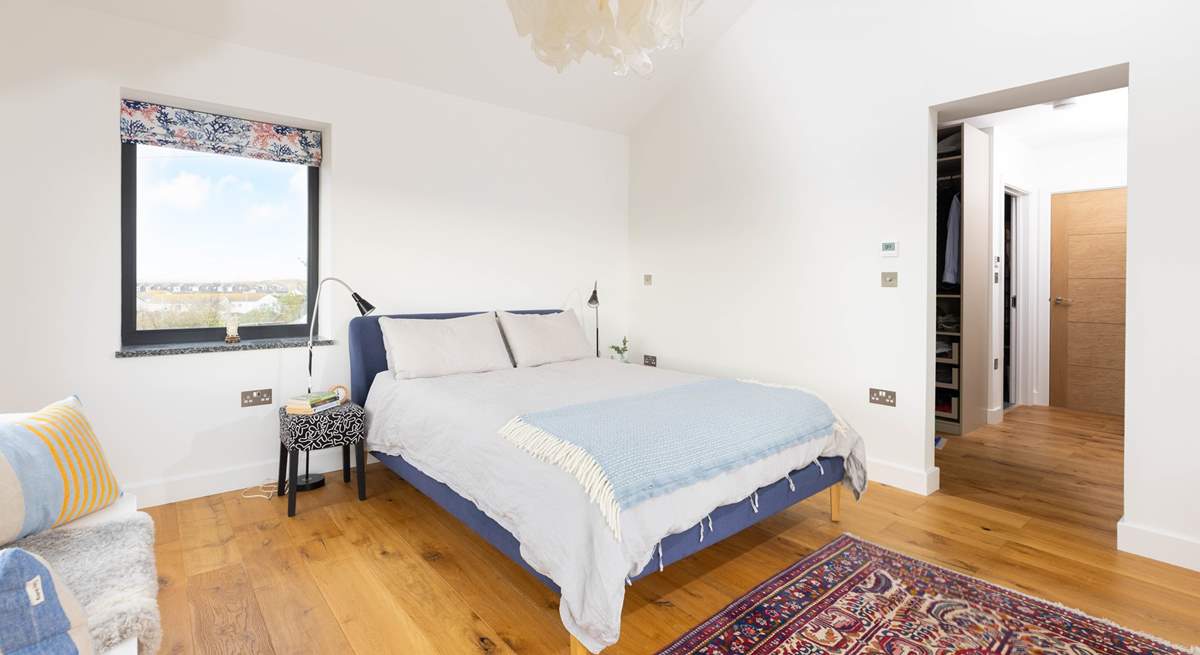 The principal bedroom is so light and airy, with sea glimpses along with a fabulous dressing-room and en suite shower-room. 