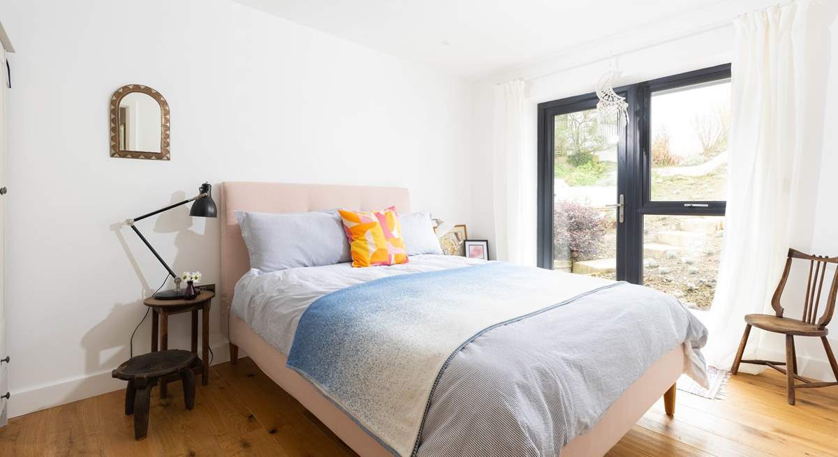 This bedroom has a cosy double bed and quiet views over the back garden. 