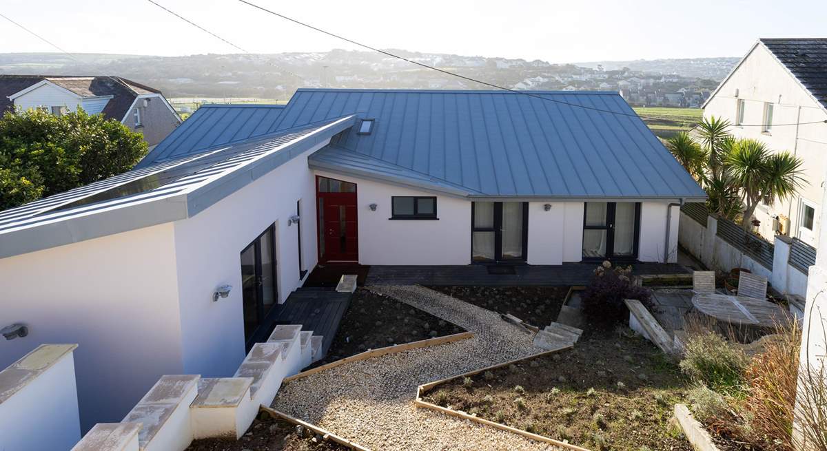 The steep winding path leads down to the front door from the car parking area. 