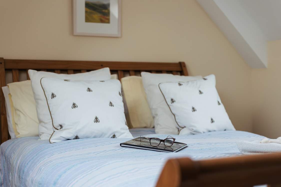 The lovely double bed awaits you.