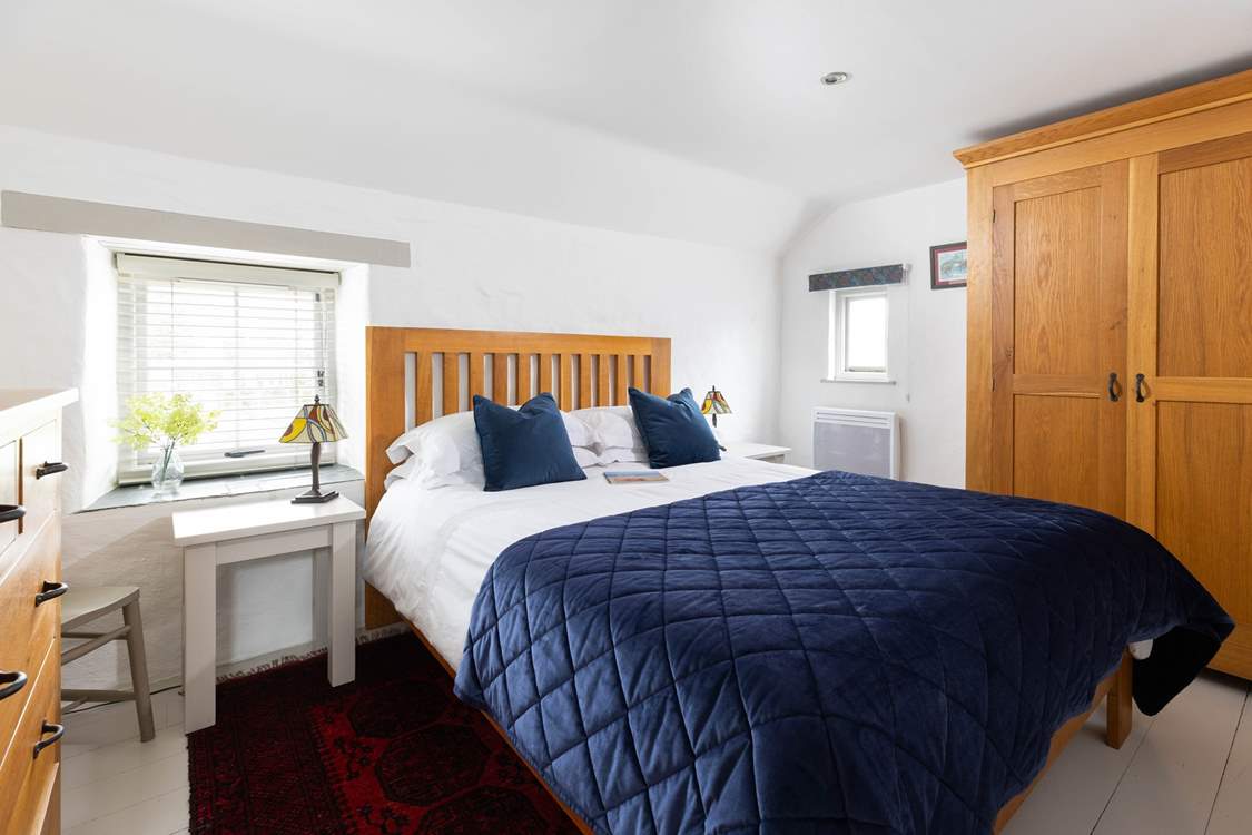 The king-size bedroom has luxury linens and a deep filled mattress.