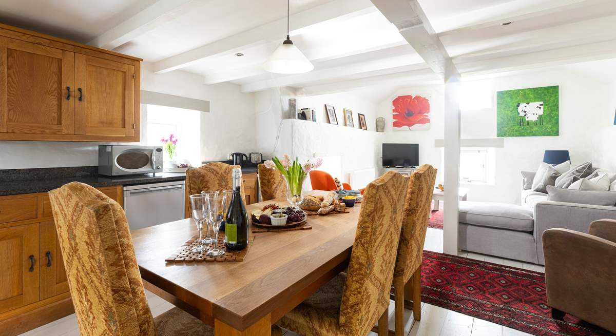 Gather round the solid oak dining-table in a space full of natural light.