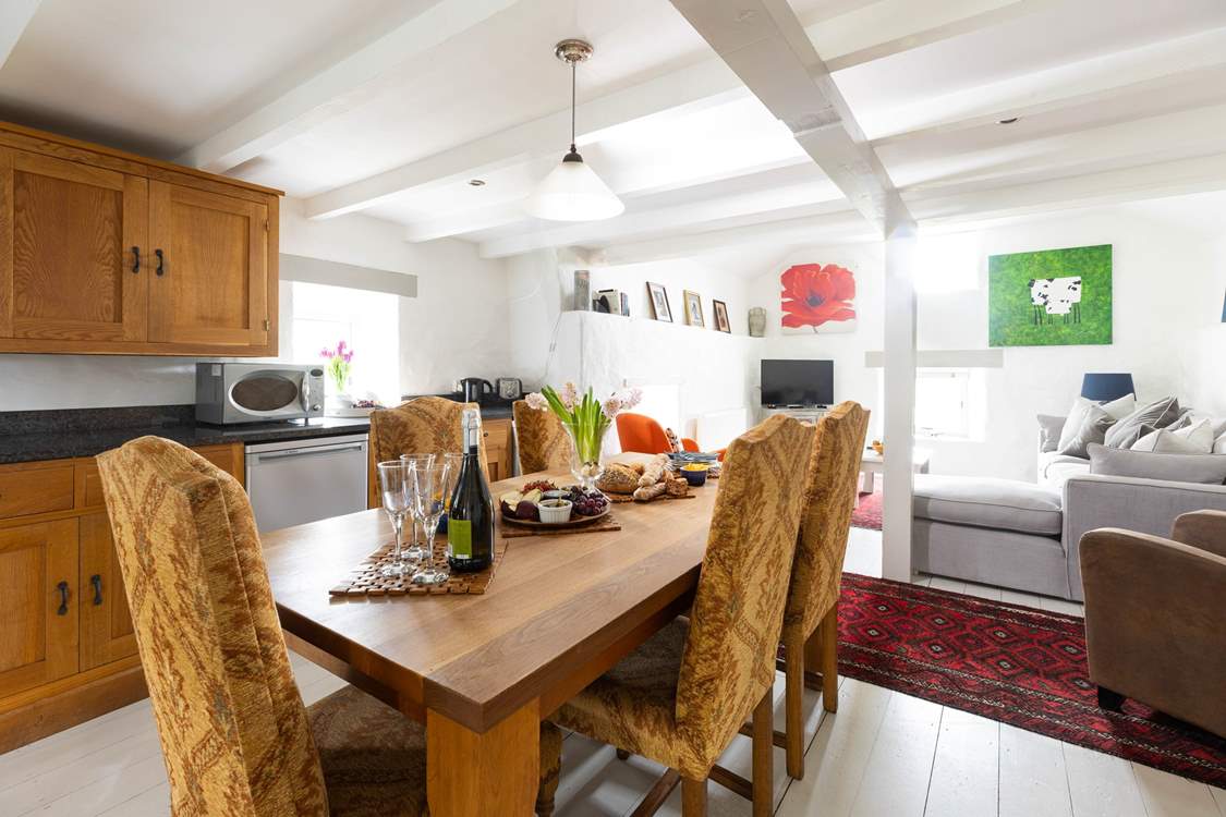 Gather round the solid oak dining-table in a space full of natural light.