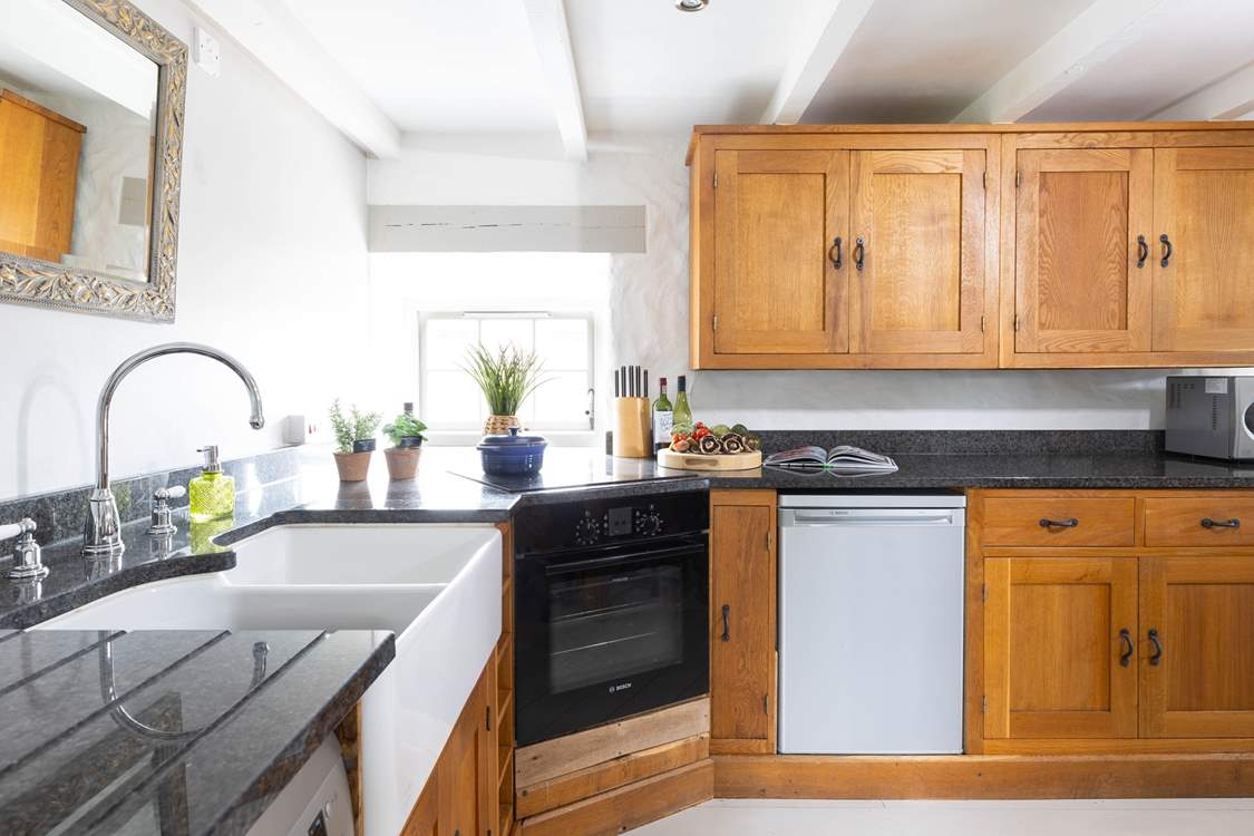 A bespoke kitchen with polished granite worktops represent the quality that continues throughout this gorgeous home.