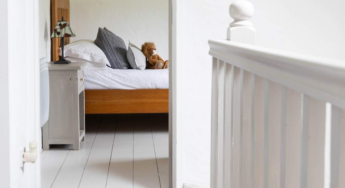 Whitewashed floors offset against tasteful vintage rugs.