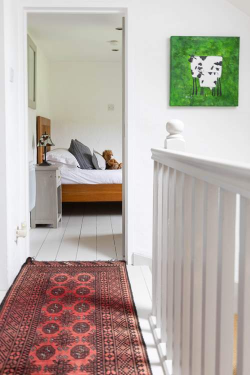 Whitewashed floors offset against tasteful vintage rugs.