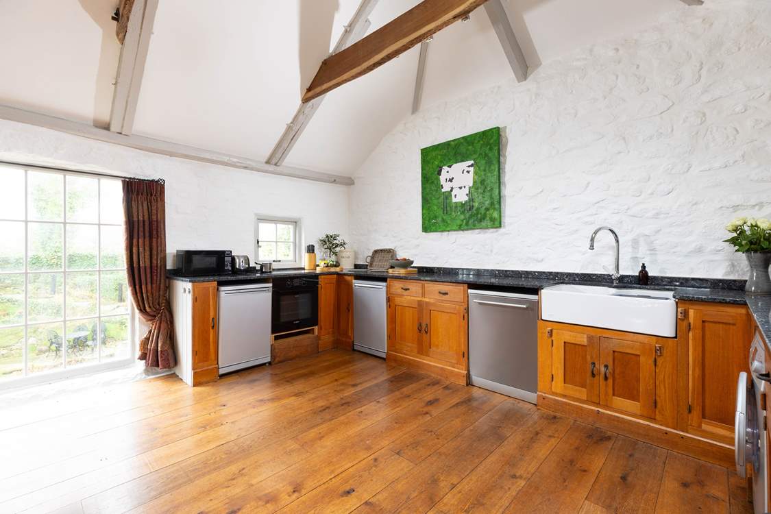 Granite worktops, large butler sink and polished floor boards make the kitchen a modern space but still appreciating the original charm.