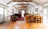 A huge open plan living space with whitewashed walls, rustic beams, a cosy wood-burner and floor to ceiling traditional windows awaits. - Thumbnail Image