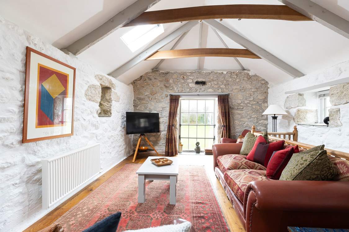The open plan living space is filled with natural light with views of the expansive gardens.