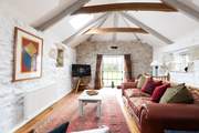 The open plan living space is filled with natural light with views of the expansive gardens.