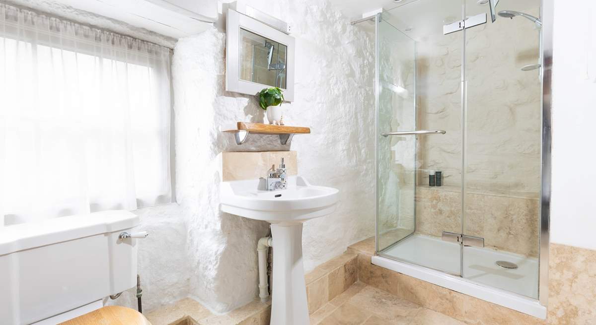 A luxury modern shower-room with power shower and marble floors.