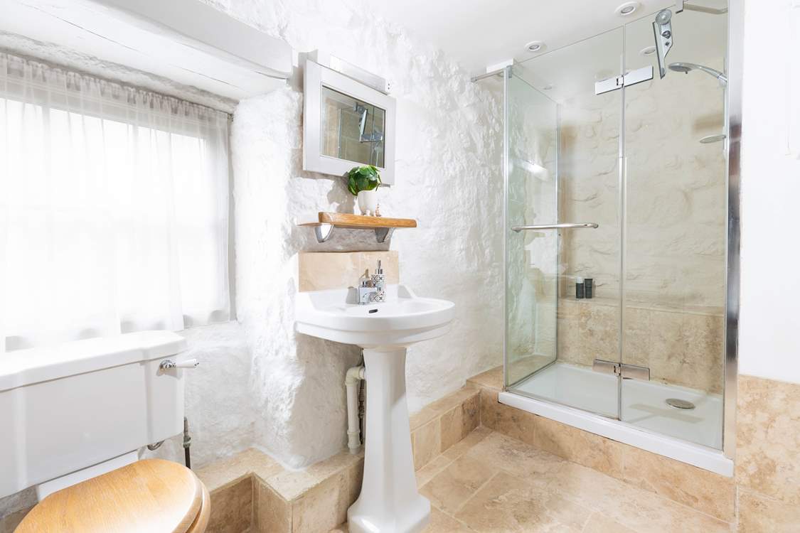 A luxury modern shower-room with power shower and marble floors.
