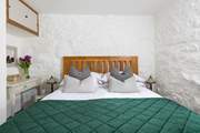The king-size bed with luxury linens.