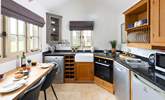 A bespoke kitchen with dining-table overlooking the beautifully kept grounds. - Thumbnail Image