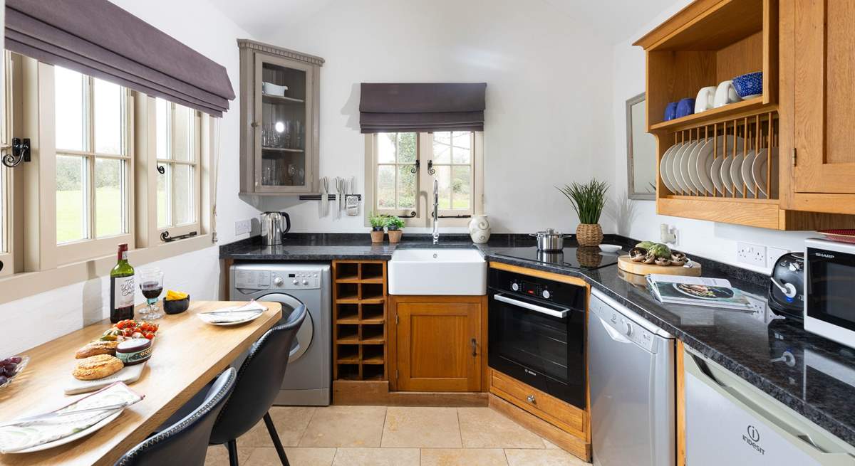 A bespoke kitchen with dining-table overlooking the beautifully kept grounds.